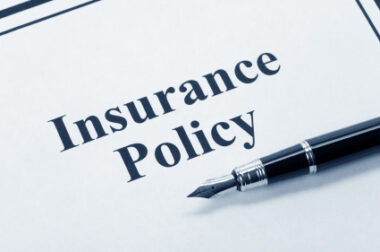 Document titled 'Insurance Policy' with fountain pen on it