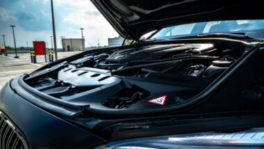 BMW with the bonnet open showing the engine