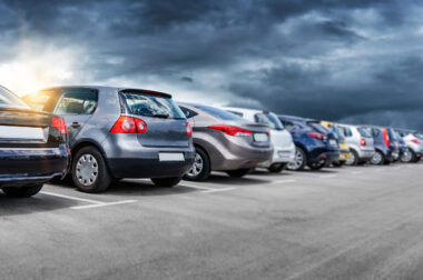 Car park of used cars with a stormy sky