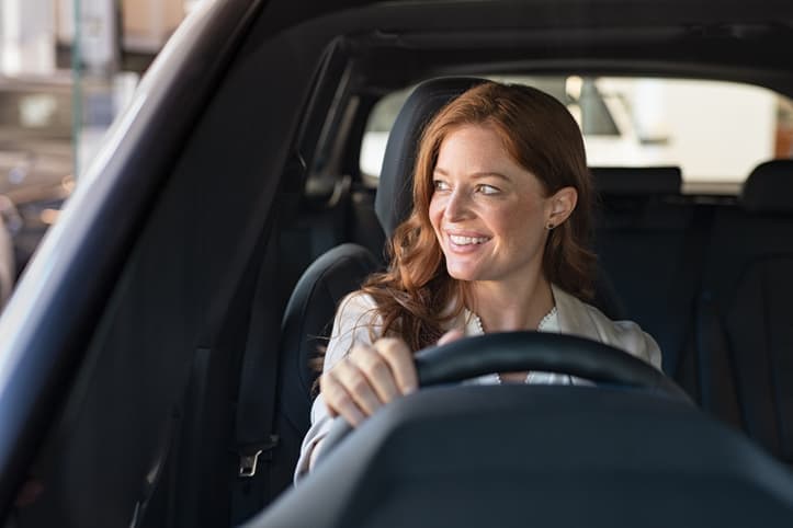 Young woman driving car