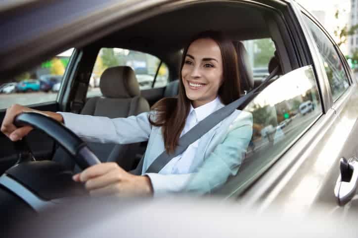 female driving a car