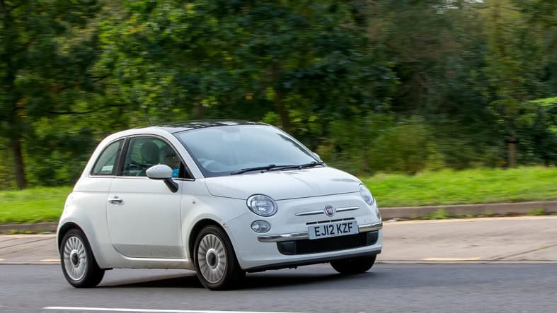 Fiat 500 car  driving on an English road.