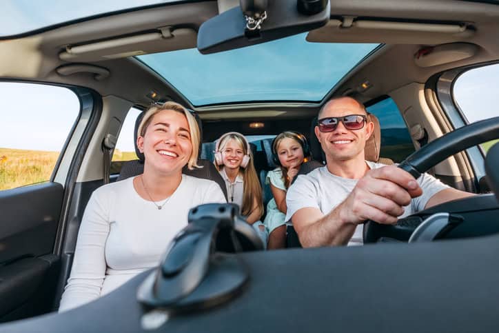 A happy family in the car enjoying their car ride