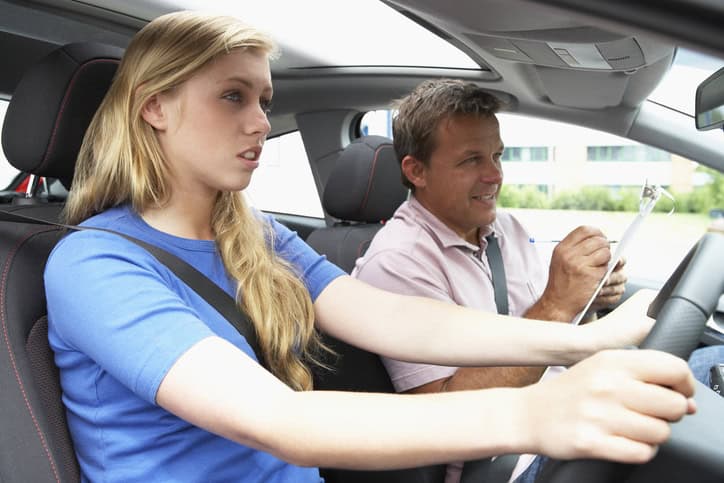 Teenage Girl Taking A Driving Lesson