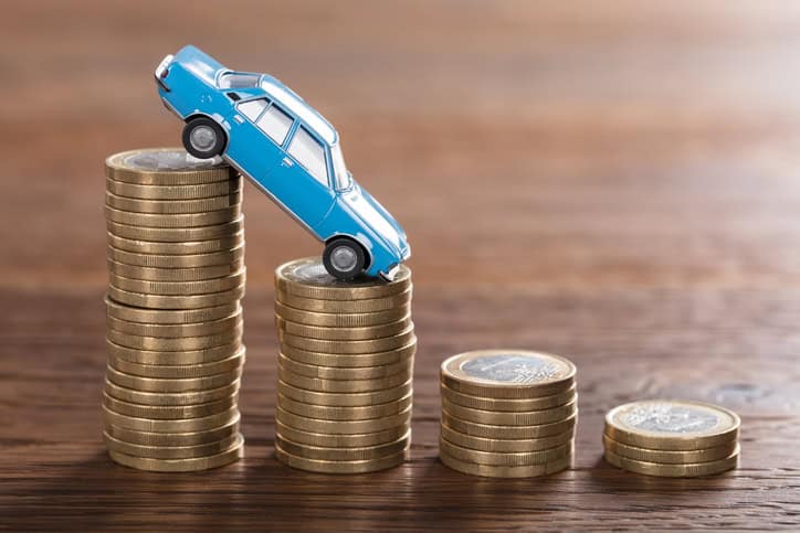 car model over a stacked coin